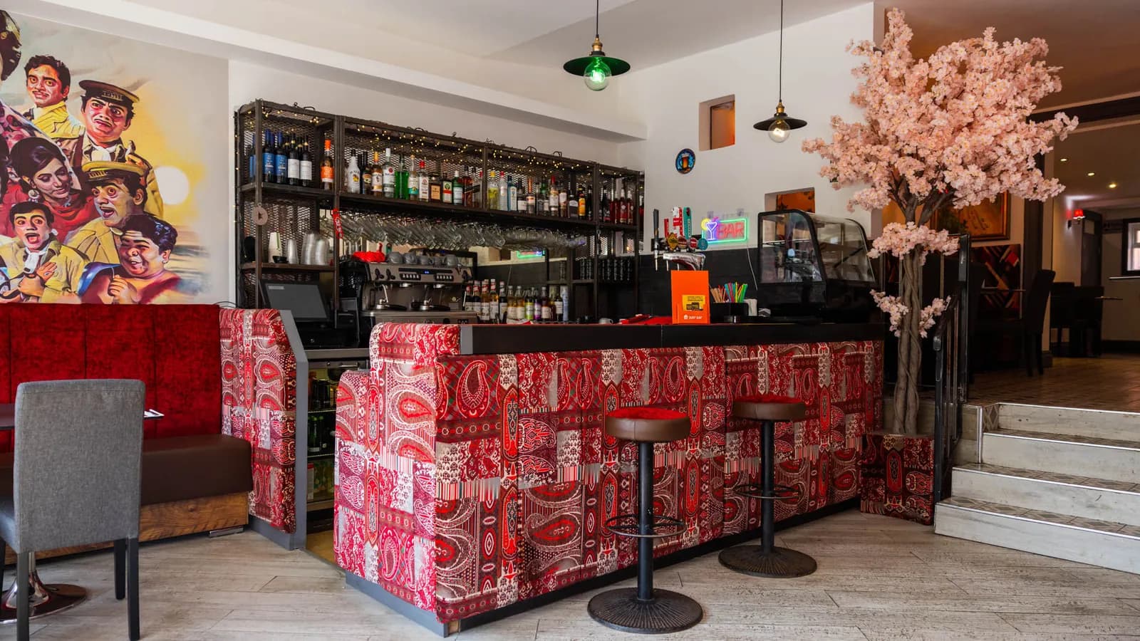 Bombay 2 Goa bar and dining room with red paisley counter, Bollywood mural and blossom tree